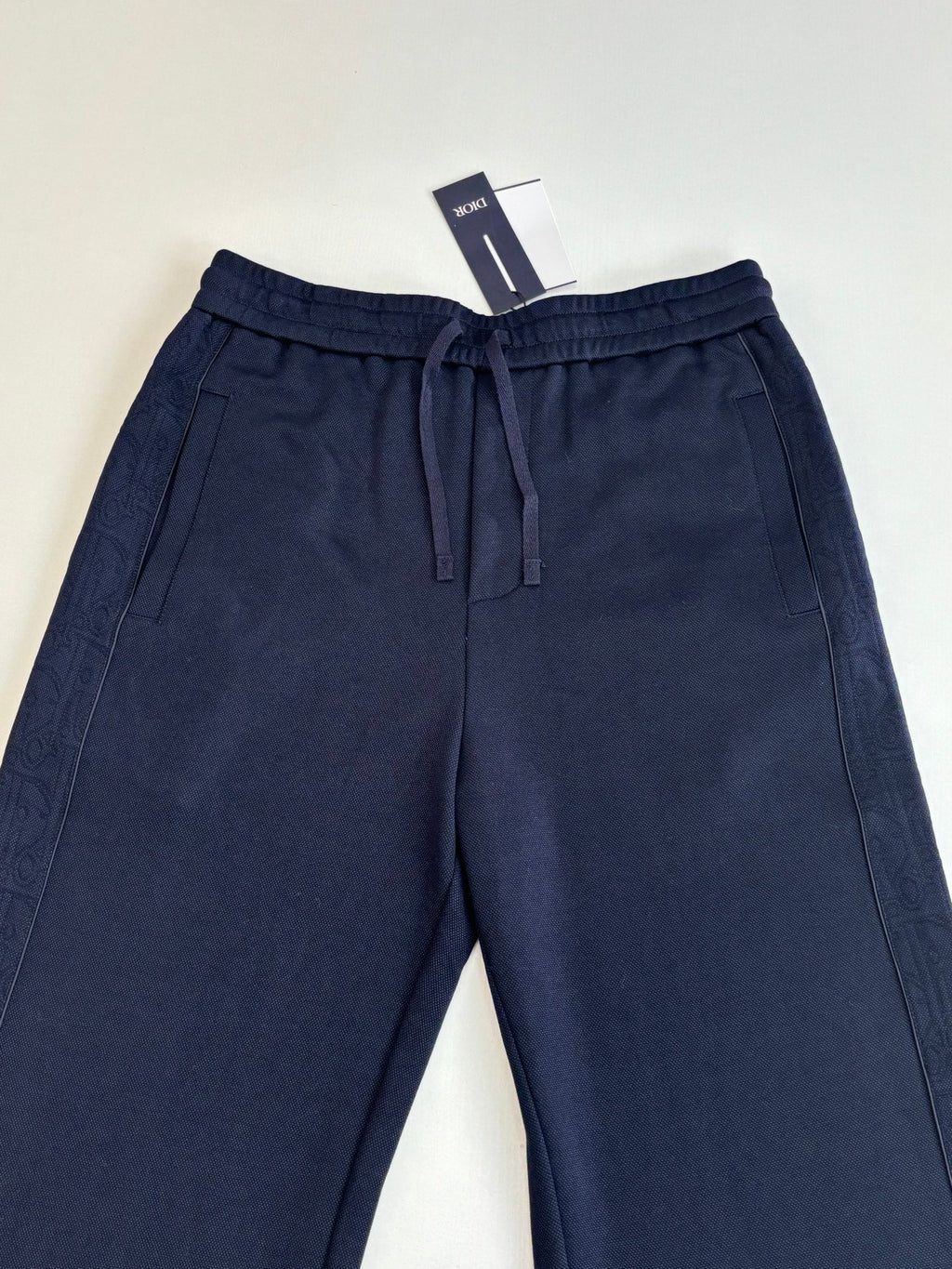 Navy pants with elastic drawstring waistband and front seam details