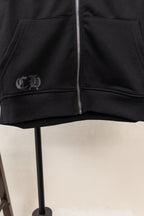 Black zip hoodie front with silver zipper and small chest emblem