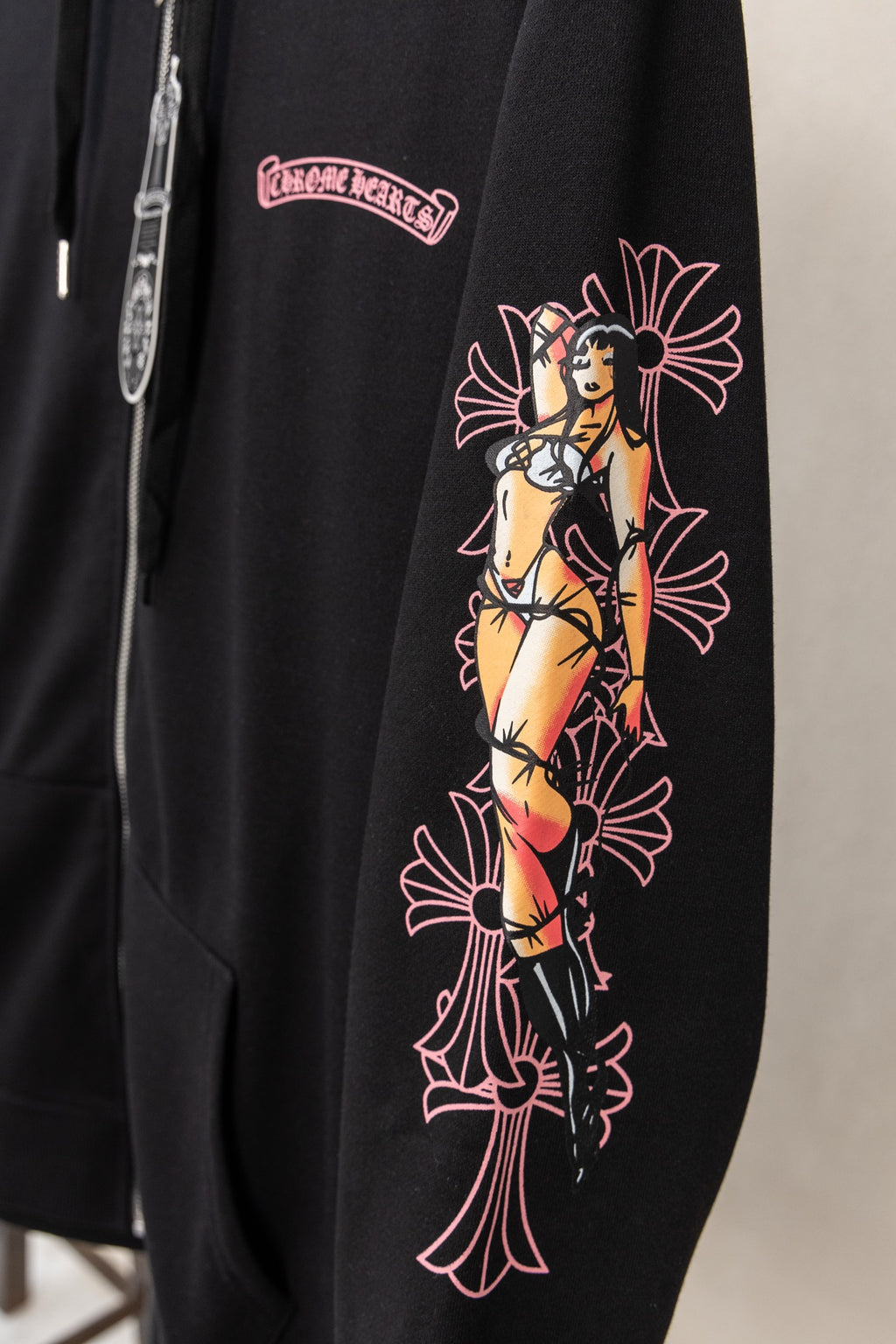 Black long-sleeve zip hoodie with colorful graphic on sleeve