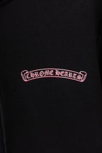 Black long-sleeve zip hoodie with Chrome Hearts logo on chest