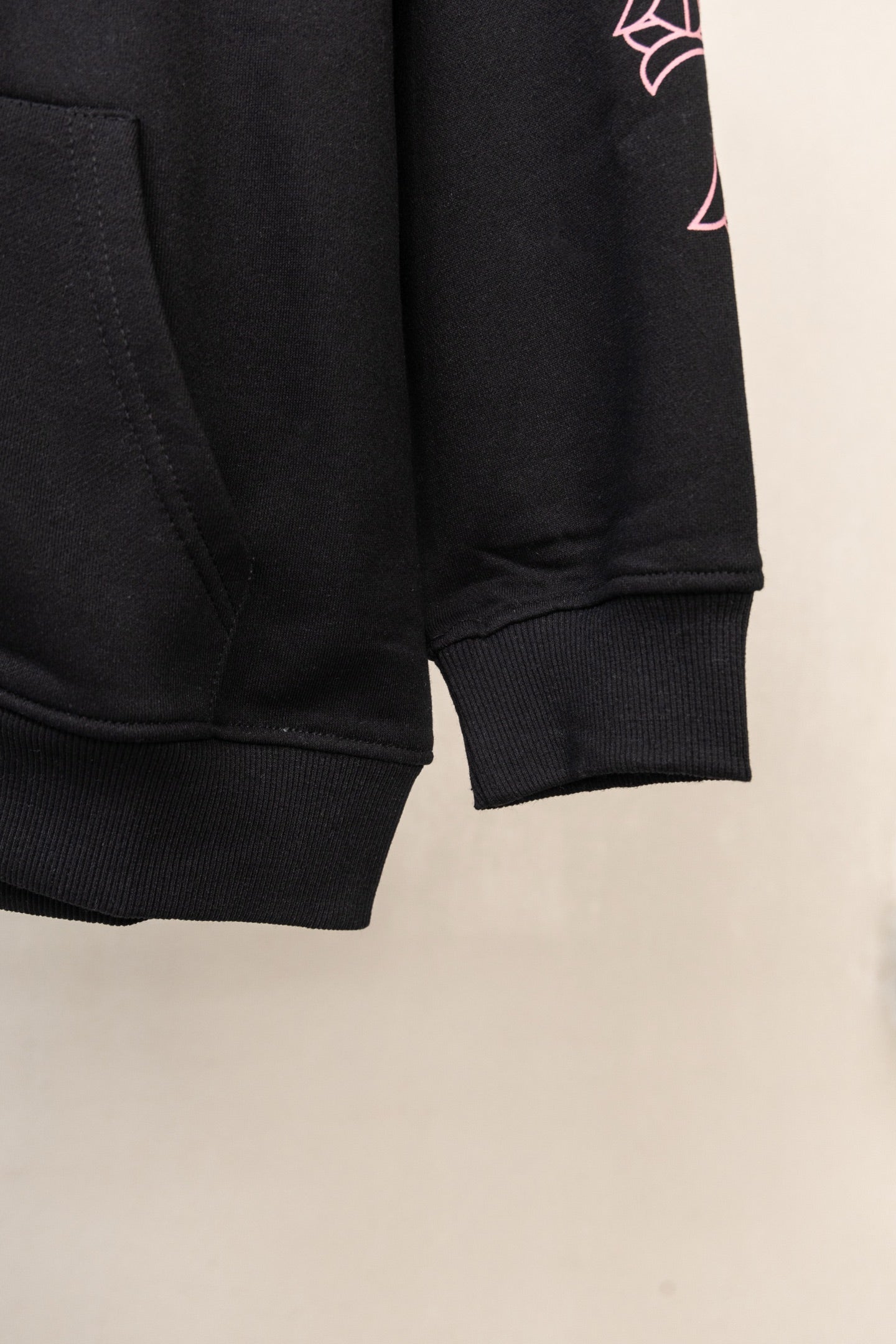Black long-sleeve zip hoodie hem and ribbed sleeve cuff