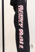 Black long-sleeve zip hoodie with pink graphic sleeve print