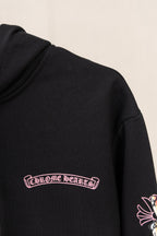 Black hoodie sleeve with red cursive logo graphic near the chest