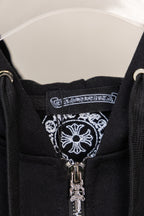 Black hoodie neckline with decorative label and visible silver zipper pull