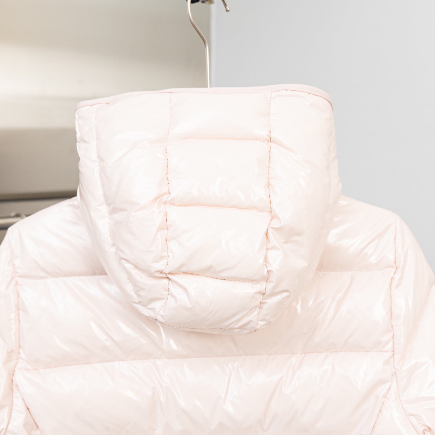 Light pink puffer jacket hood and quilted back view