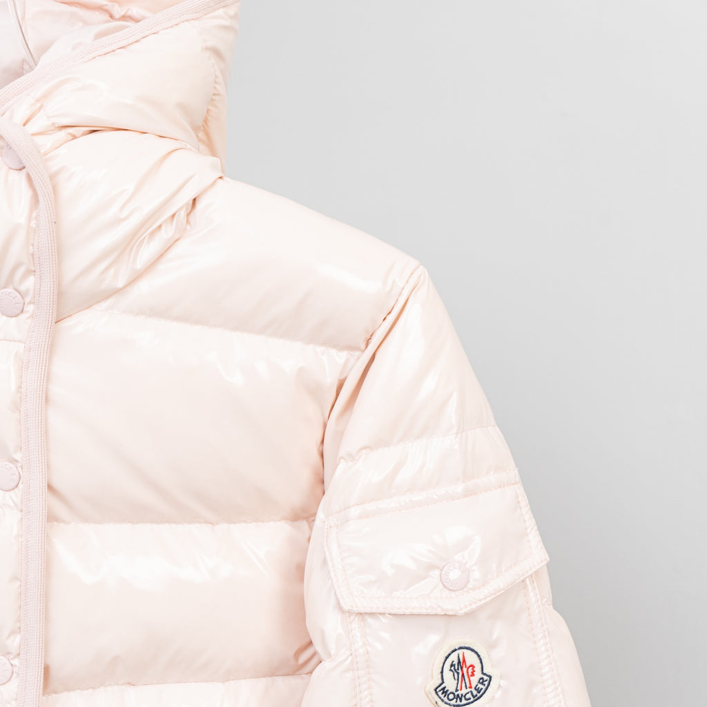 Light pink puffer jacket sleeve with embroidered logo patch