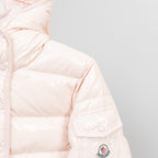 Light pink puffer jacket sleeve with embroidered logo patch