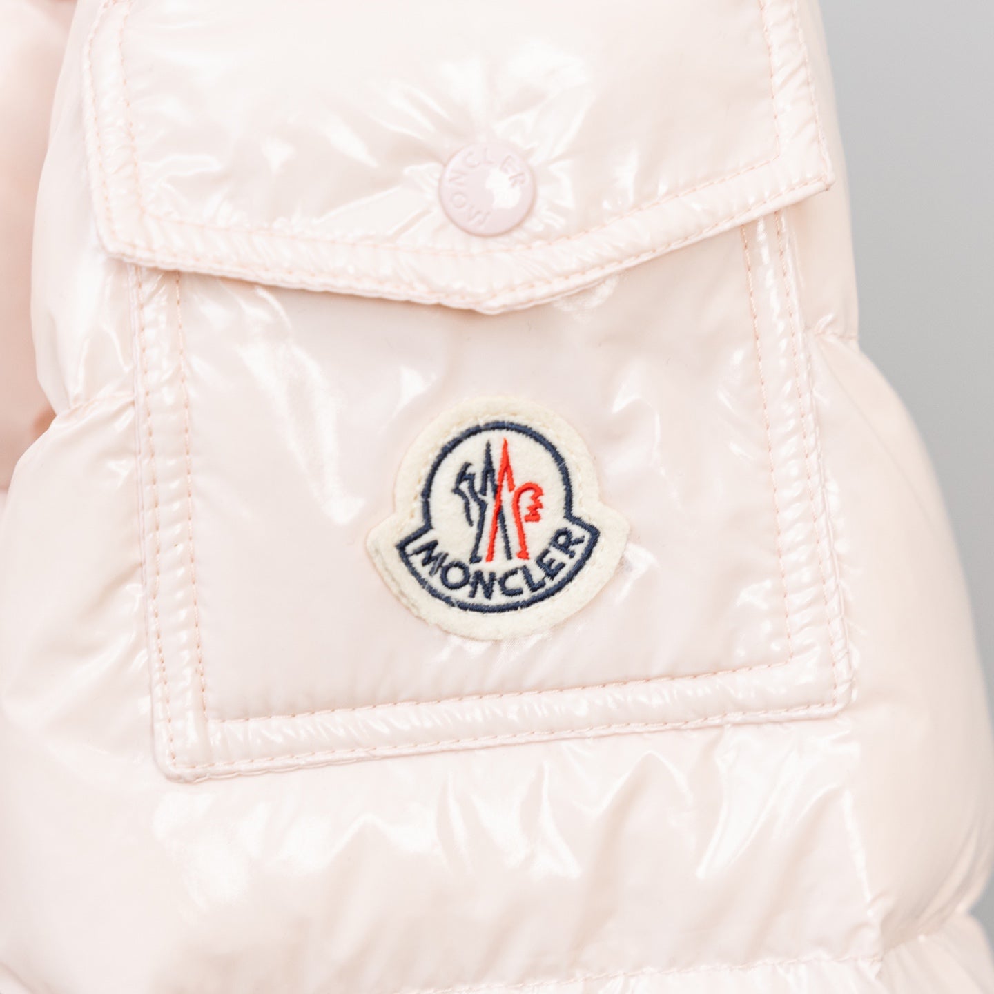 Light pink puffer jacket logo patch on chest pocket
