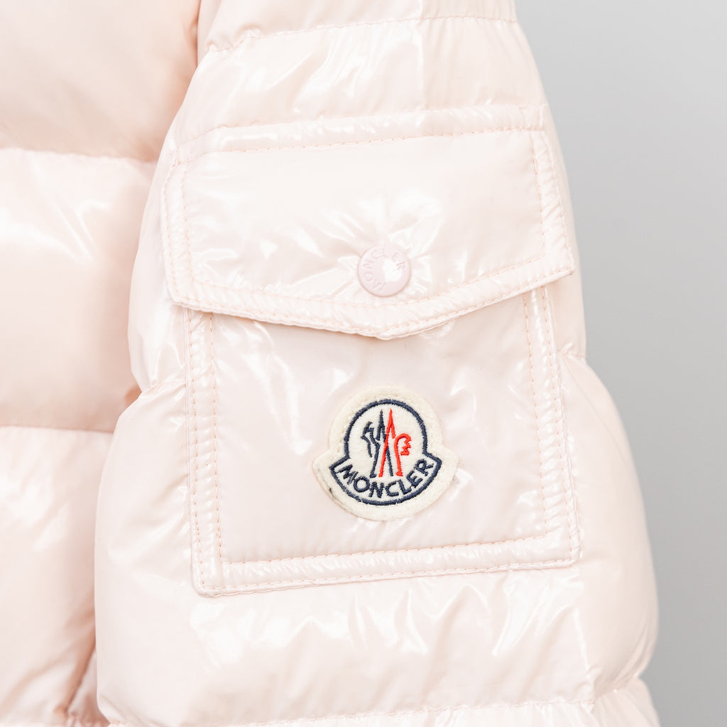 Light pink puffer jacket chest pocket with logo patch and snap tab