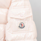 Light pink puffer jacket chest pocket with logo patch and snap tab