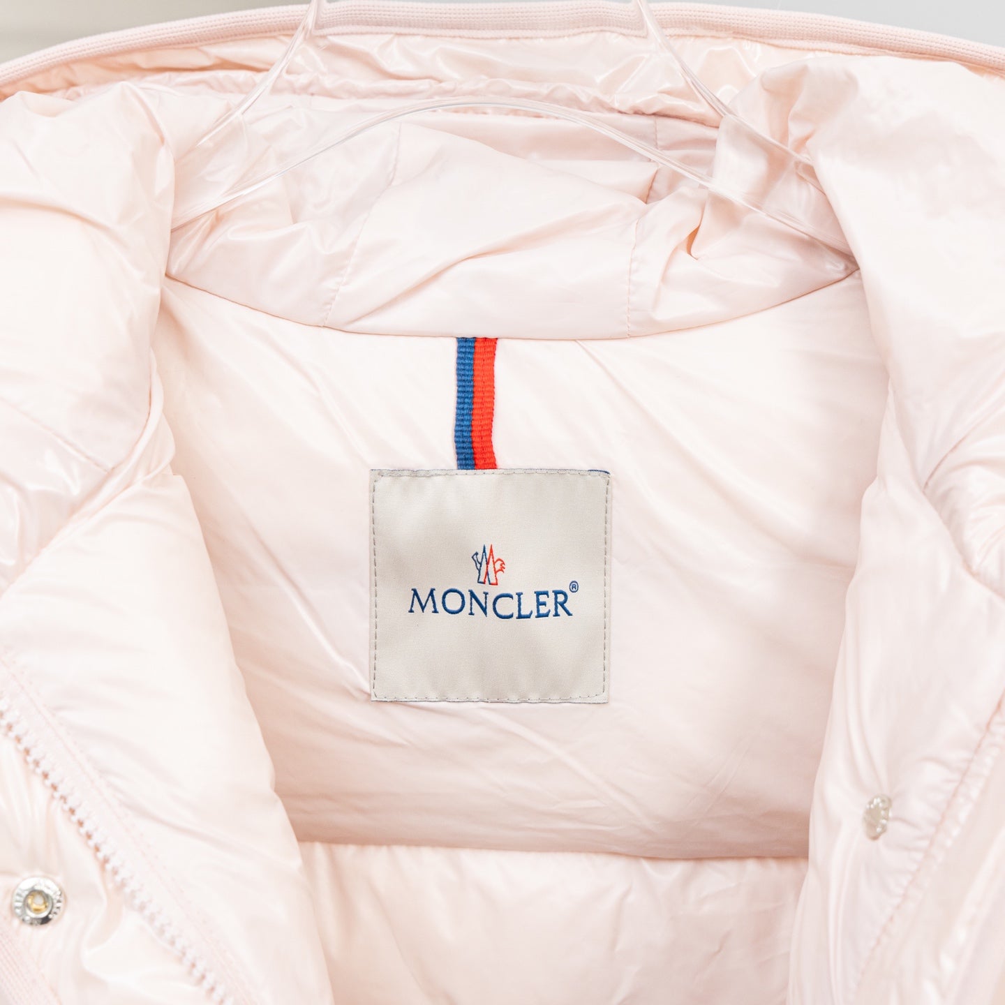 Moncler logo patch on the inner lining of a hooded puffer jacket