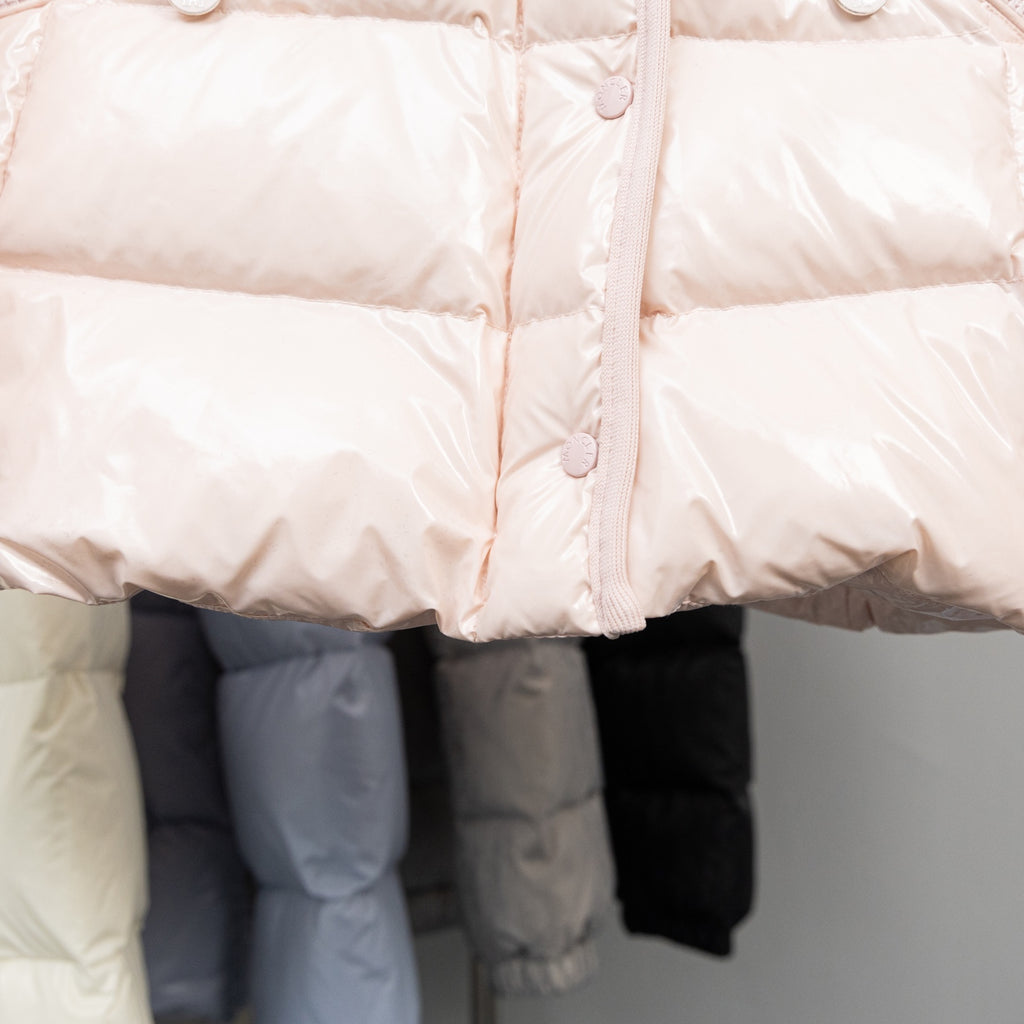 Light pink Moncler long puffer jacket front with buttoned placket