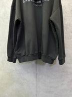 Black Dior hooded sweatshirt with ribbed hem and long sleeves.
