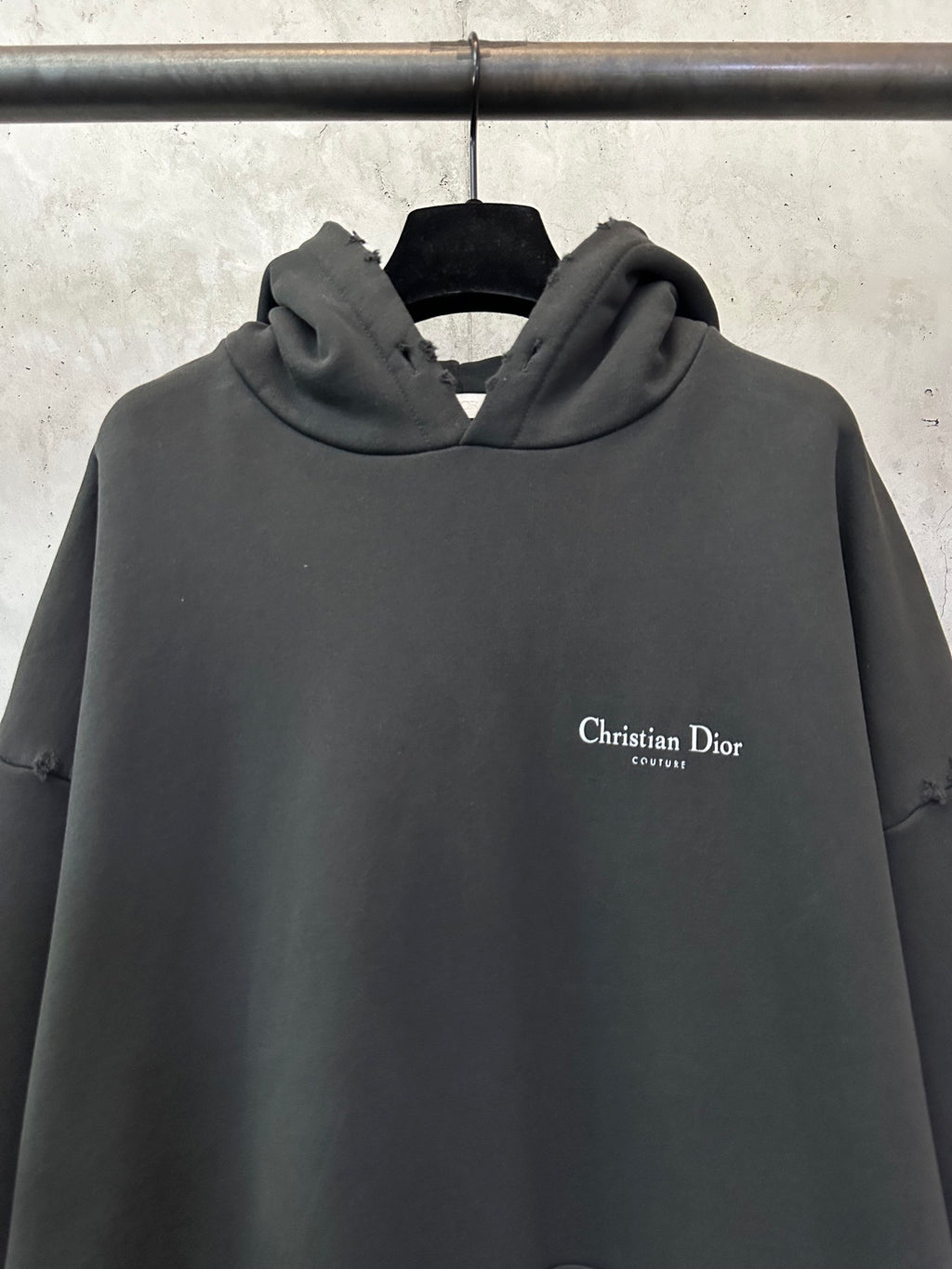 Black Dior hooded sweatshirt with small chest logo on the front.