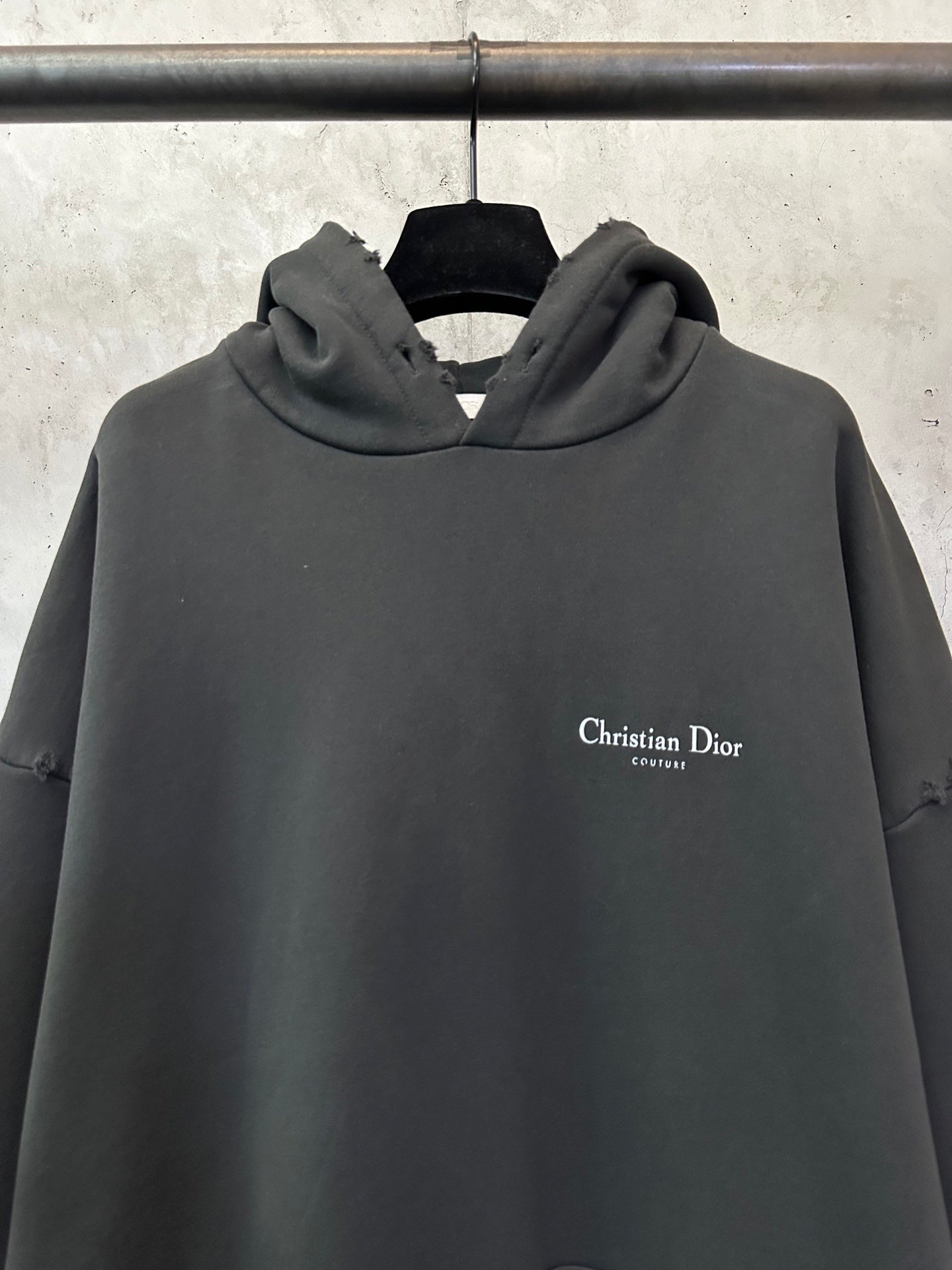 Black Dior hooded sweatshirt with small chest logo on the front.