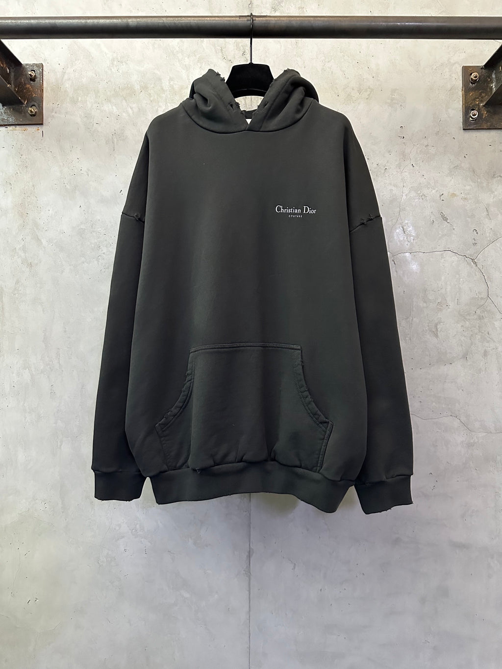 Black Dior hooded sweatshirt with front pocket and small chest logo.