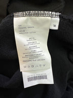Inside label on dark hoodie, cotton content and care instructions.