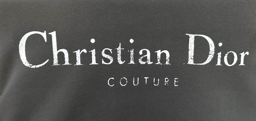 Black fabric with Christian Dior and COUTURE logo print.