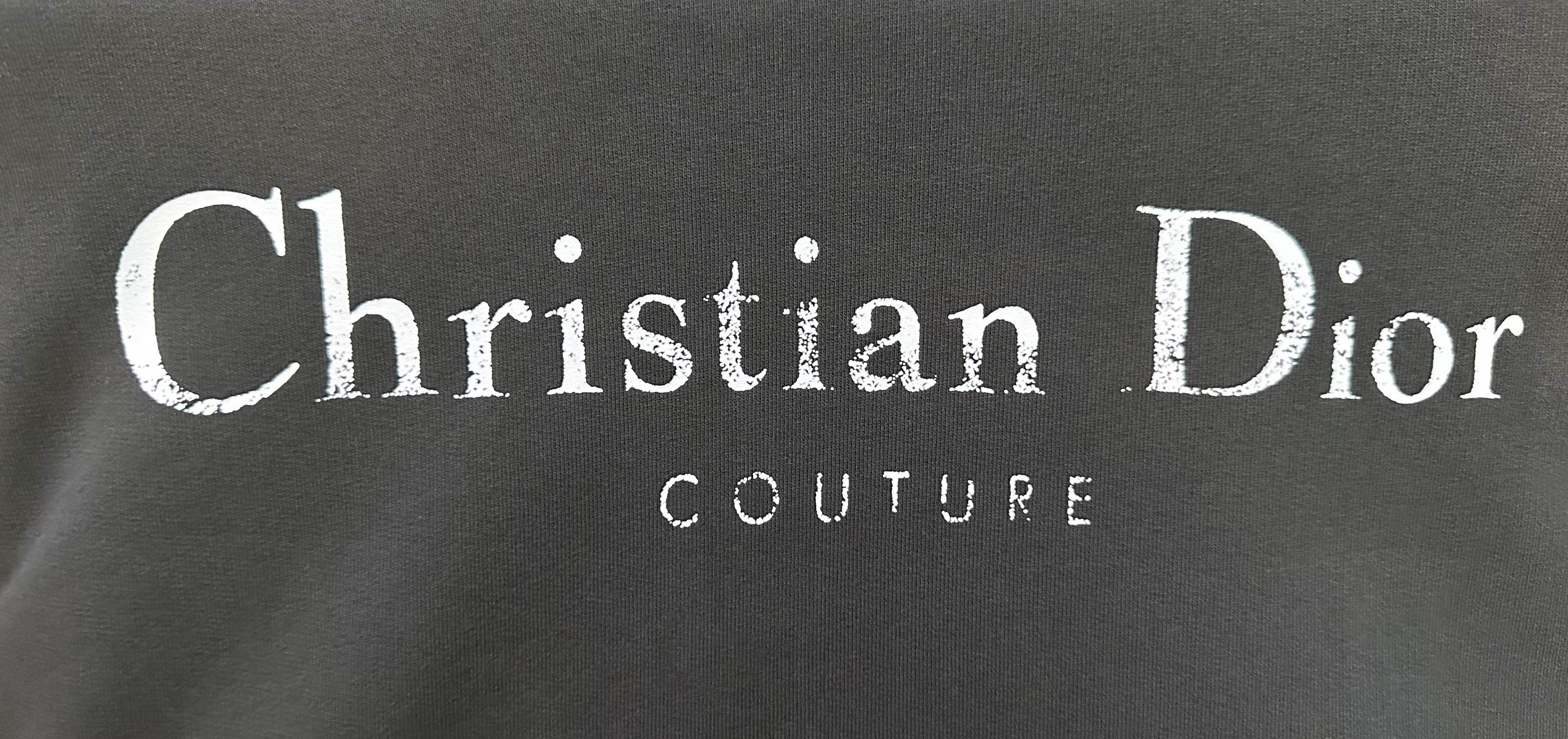 Black fabric with Christian Dior and COUTURE logo print.