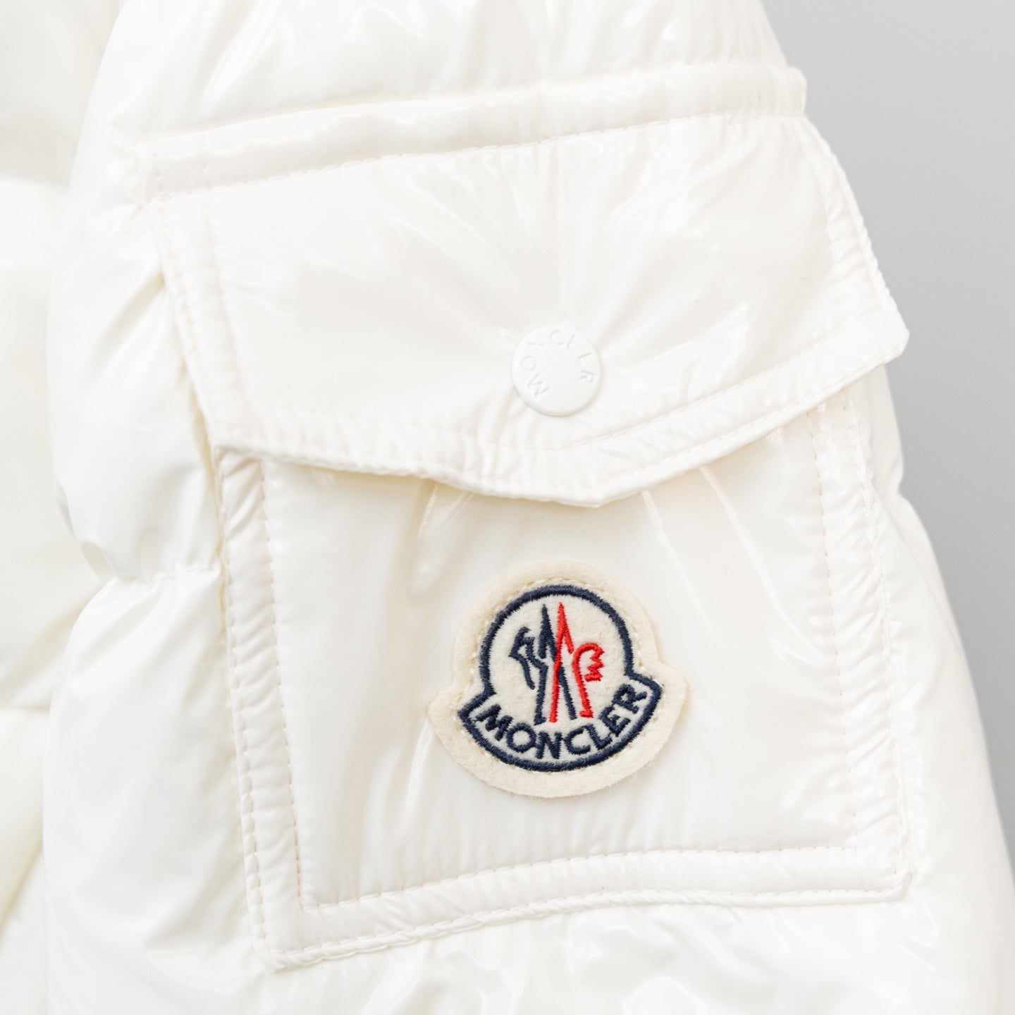 Moncler long white puffer jacket, round logo patch on chest pocket flap