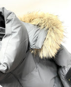 Gray puffer jacket close-up with faux fur hood trim and quilted stitching