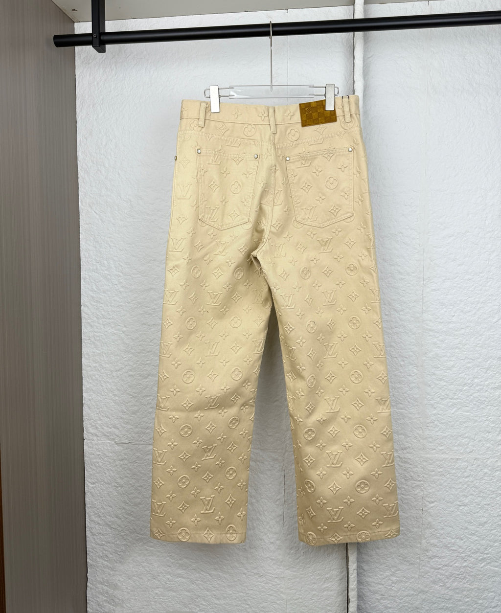 Beige Louis Vuitton monogram wide-leg pants with belt loops and back pockets