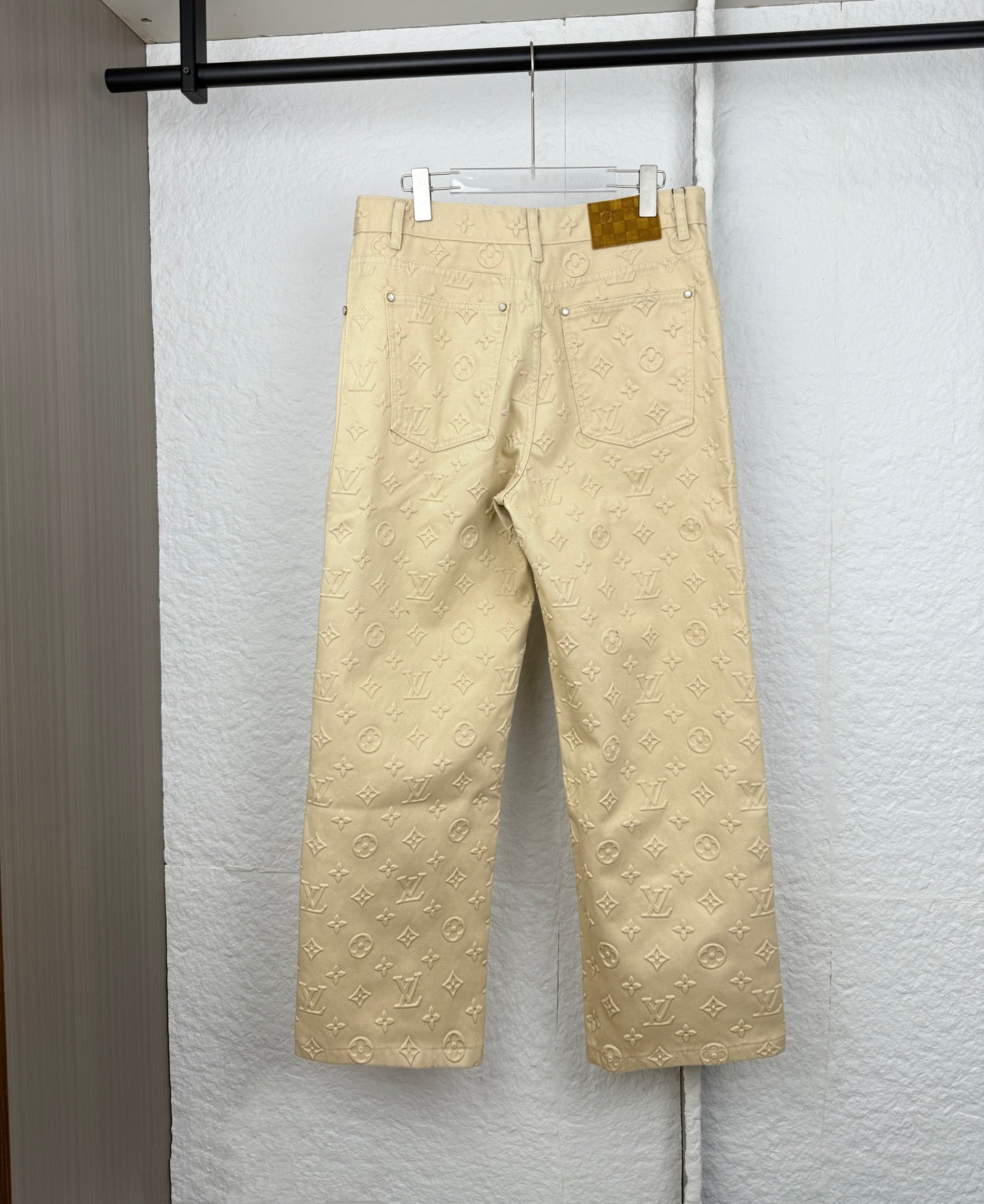 Beige Louis Vuitton monogram wide-leg pants with belt loops and back pockets