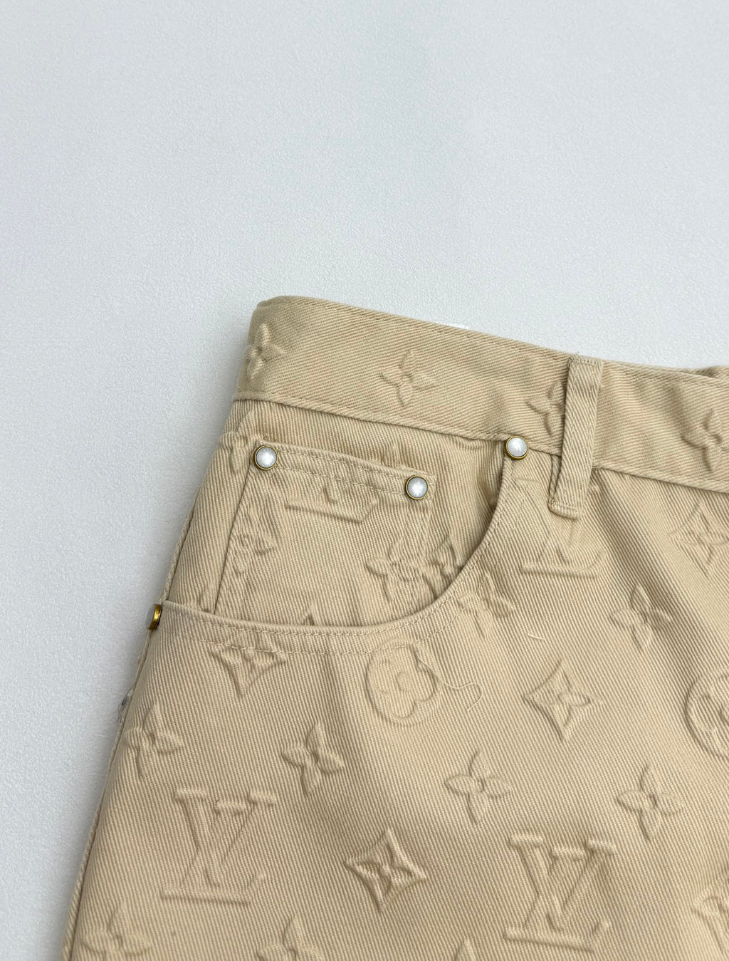 Beige Louis Vuitton monogram pants with curved front pocket and snap buttons