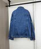 Blue denim jacket shown from the back with yoke seams and button cuffs