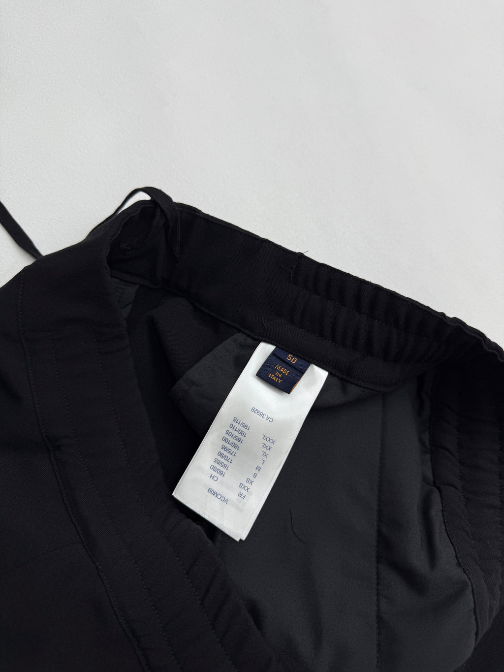 Louis Vuitton black pants interior with white size and care label