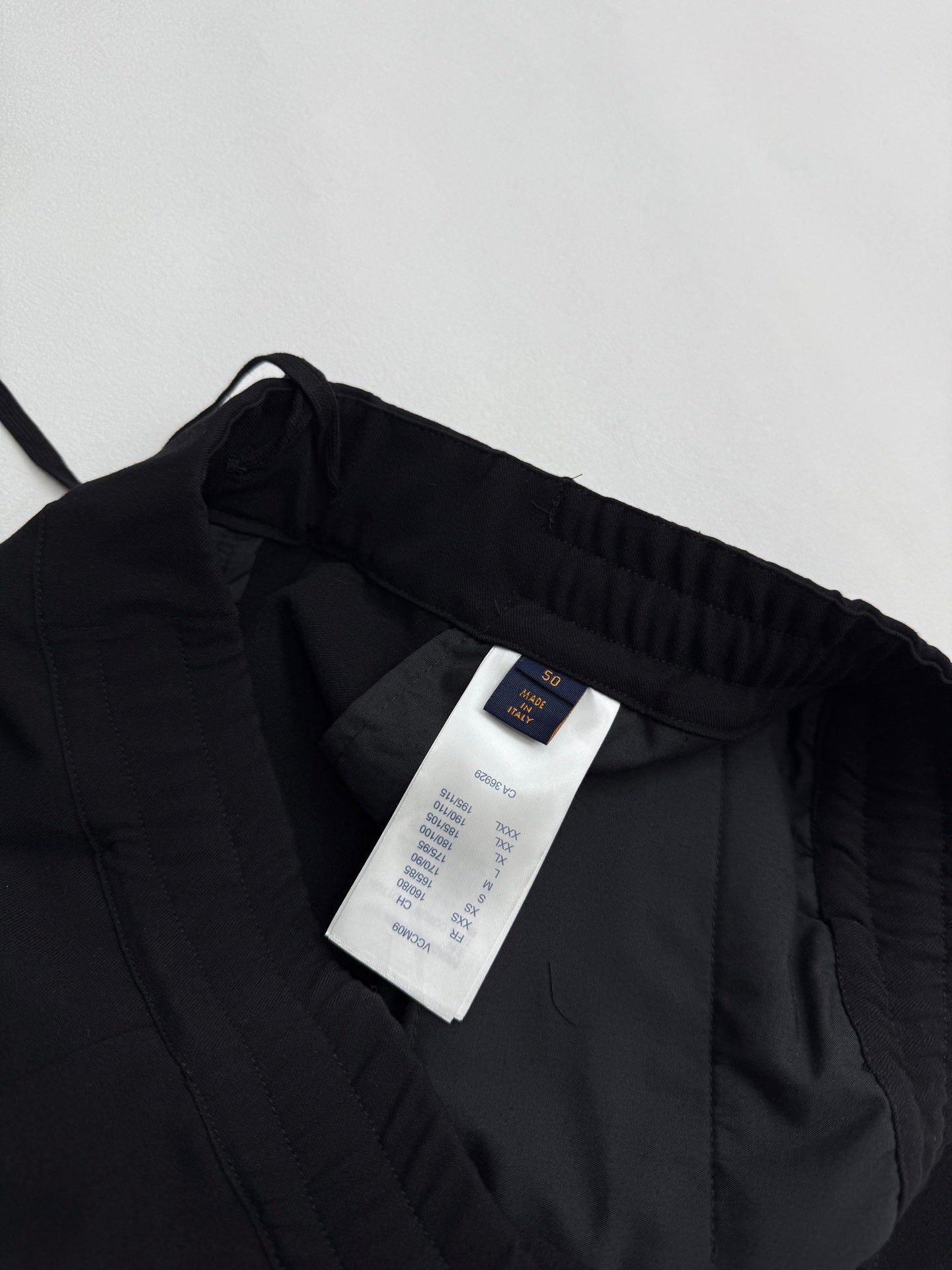 Louis Vuitton black pants interior with white size and care label