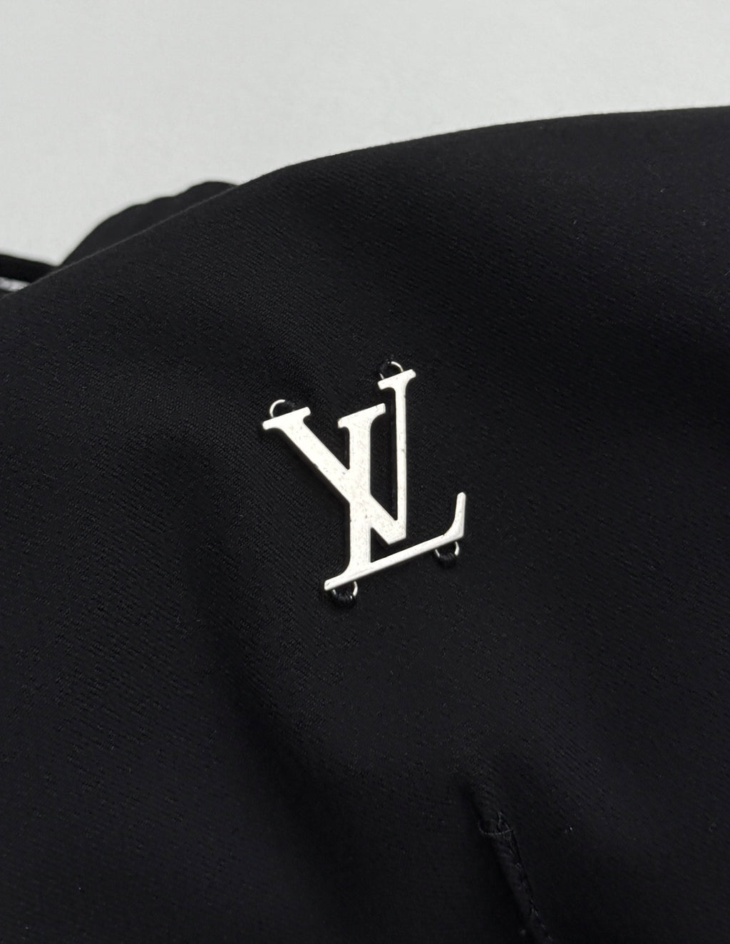 Louis Vuitton black pants with metallic LV logo emblem