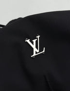 Louis Vuitton black pants with metallic LV logo emblem