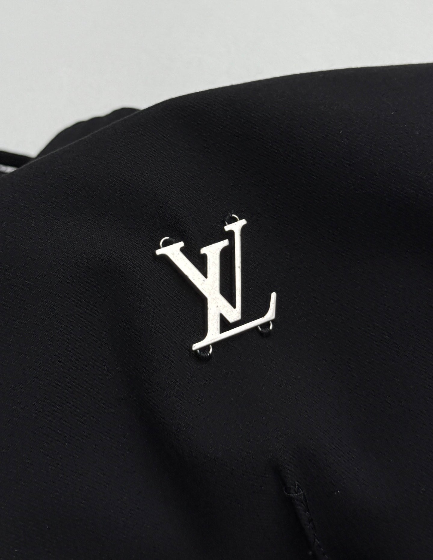 Louis Vuitton black pants with metallic LV logo emblem