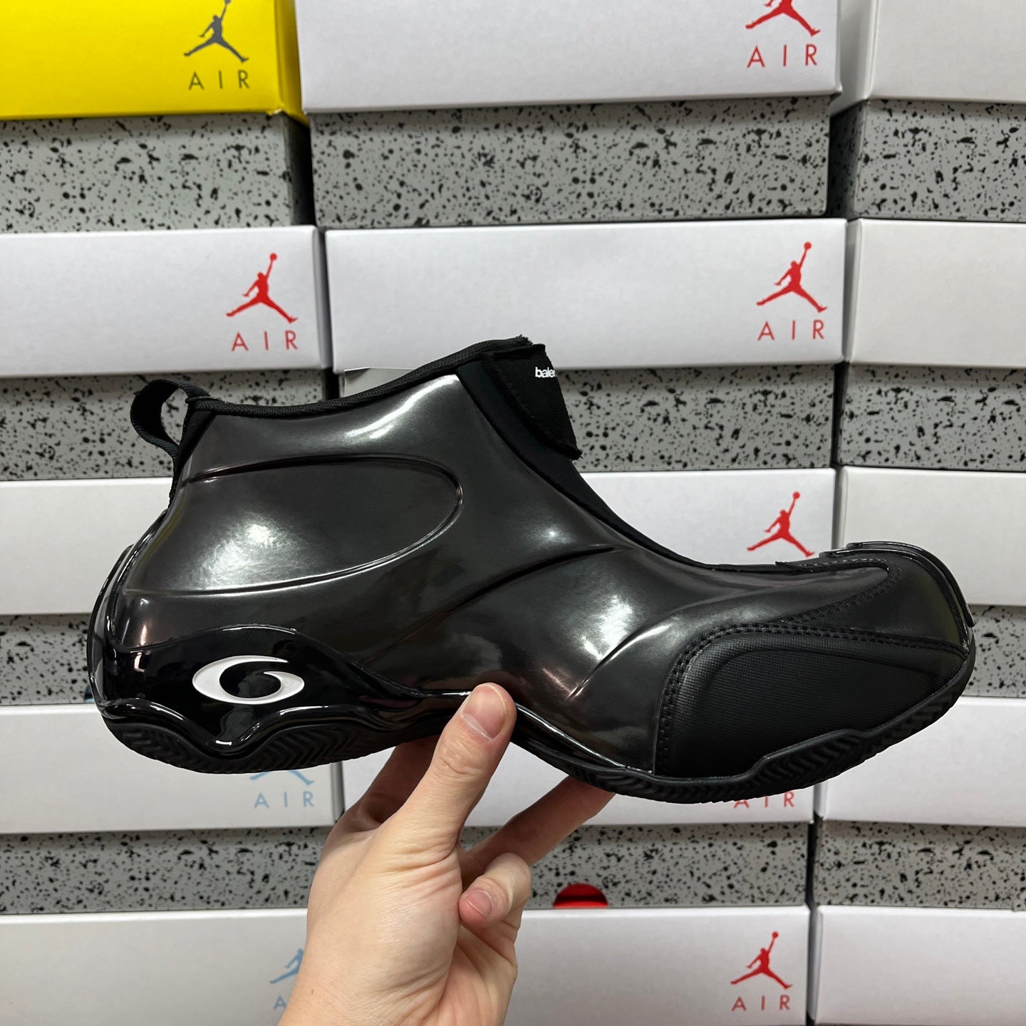 Unisex black glossy sneakers with circular air-style detail on toe