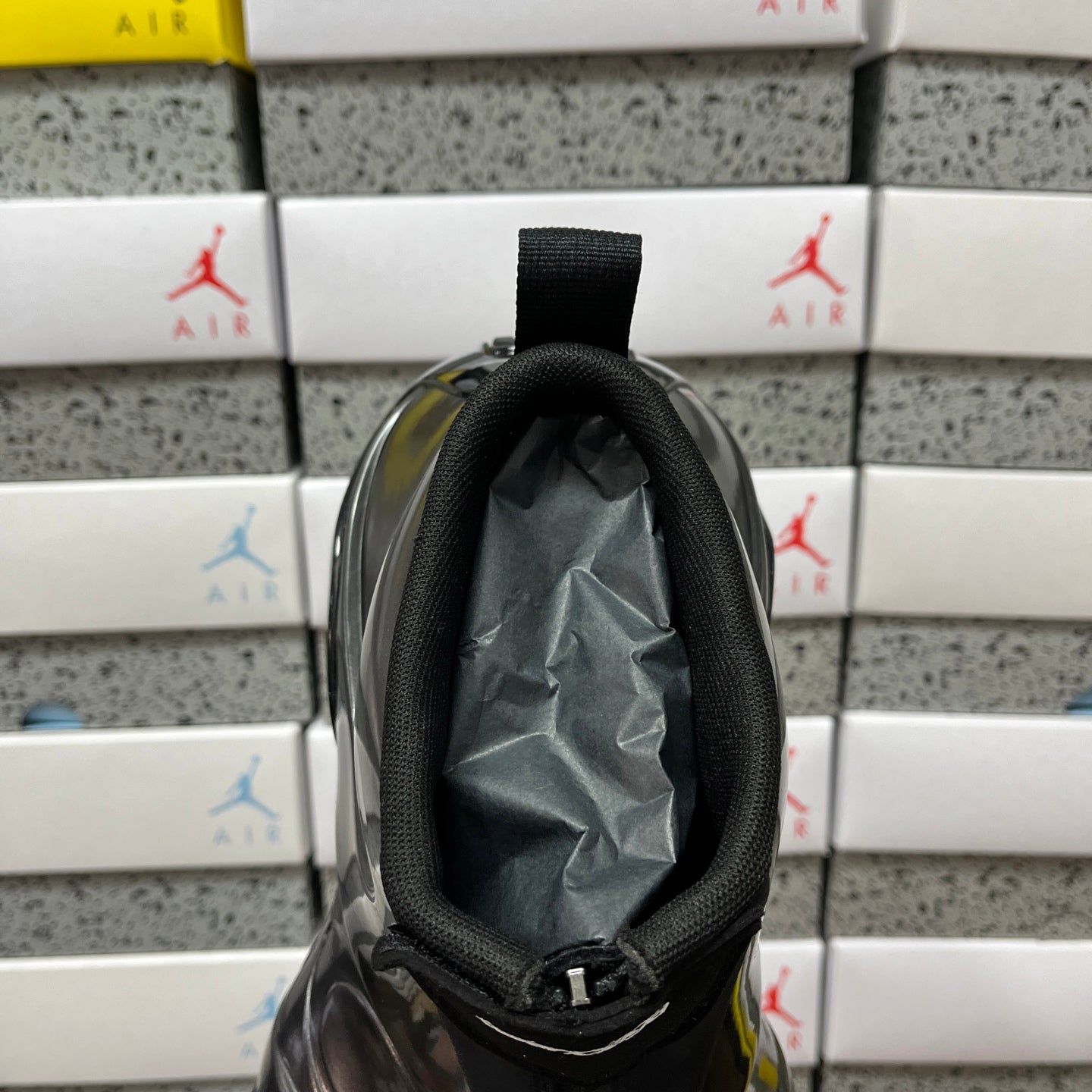 Unisex black sneaker tongue opening with mesh-lined collar