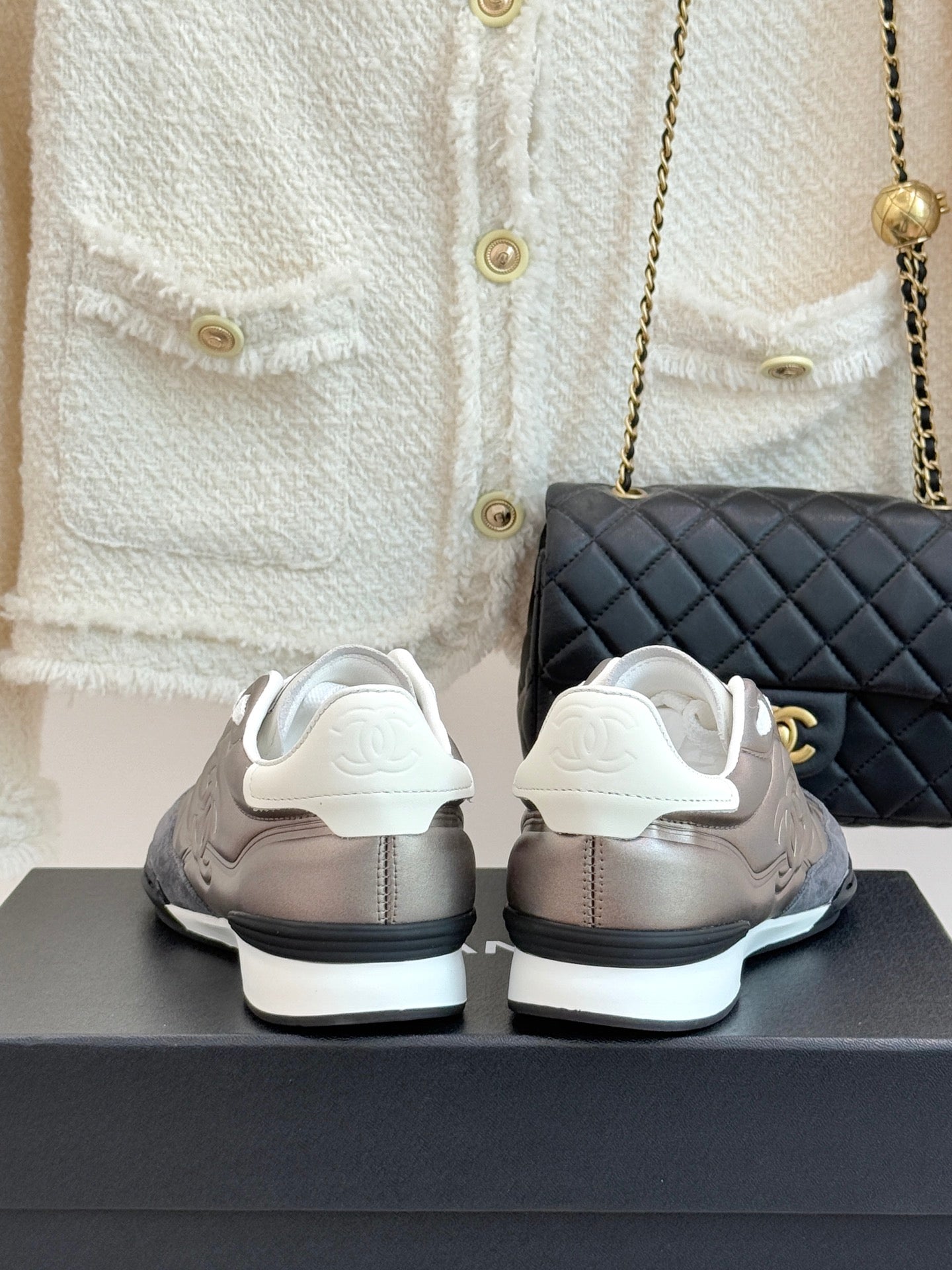Back view of ladies sneakers in metallic beige with white heels and white rubber soles