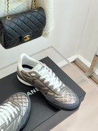 Ladies sneakers on display: metallic beige pair with white laces and white soles