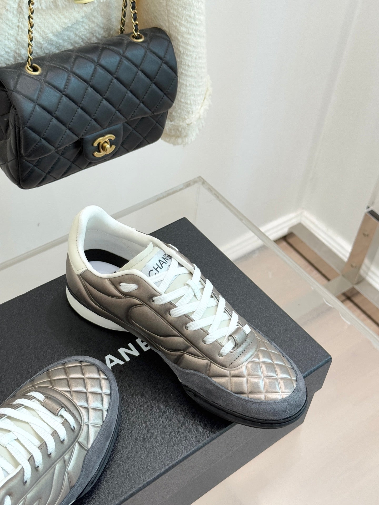 Ladies sneakers on display: metallic beige pair with white laces and white soles