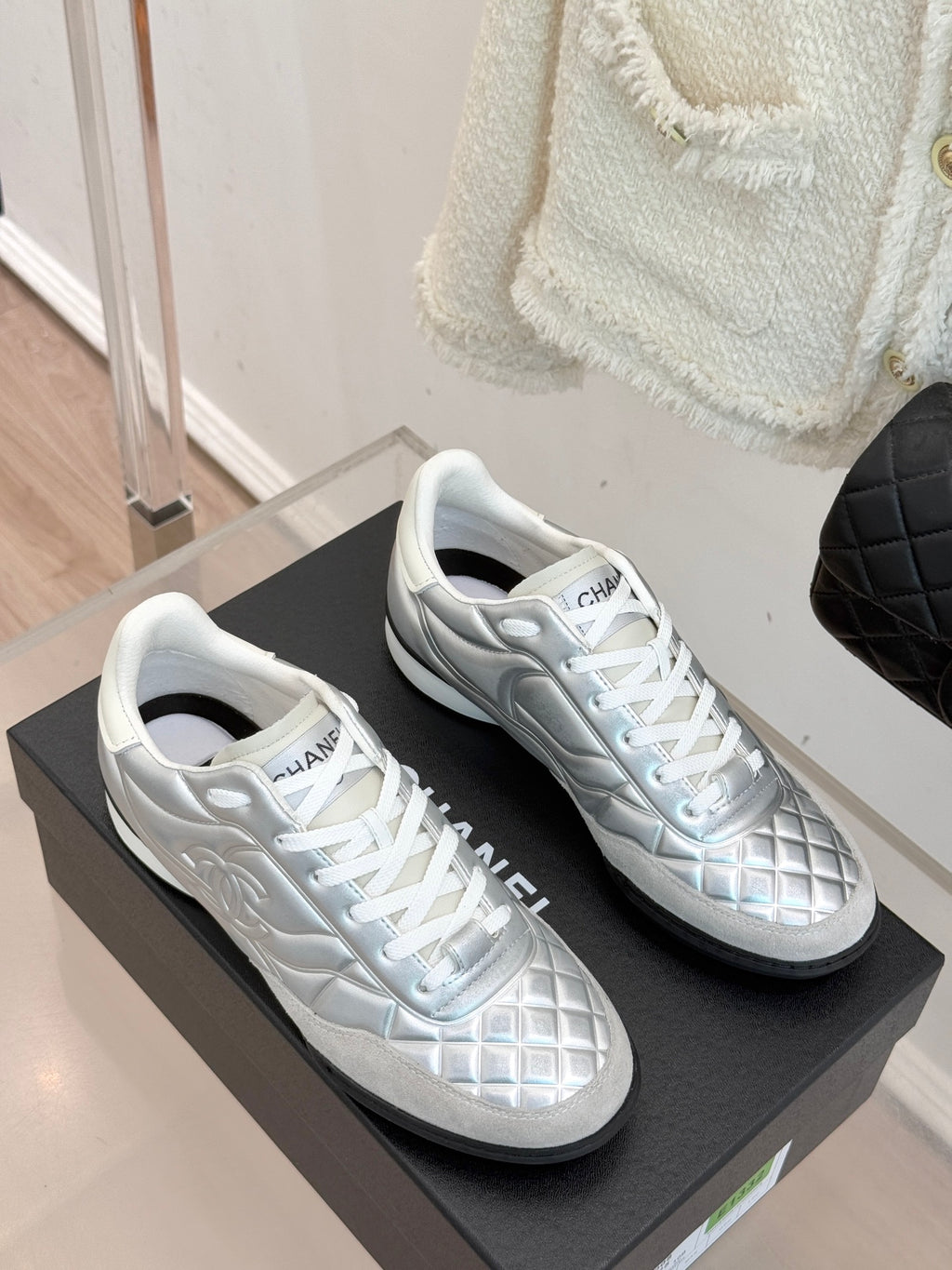 Chanel ladies white sneakers pair, lace-up style with quilted overlays