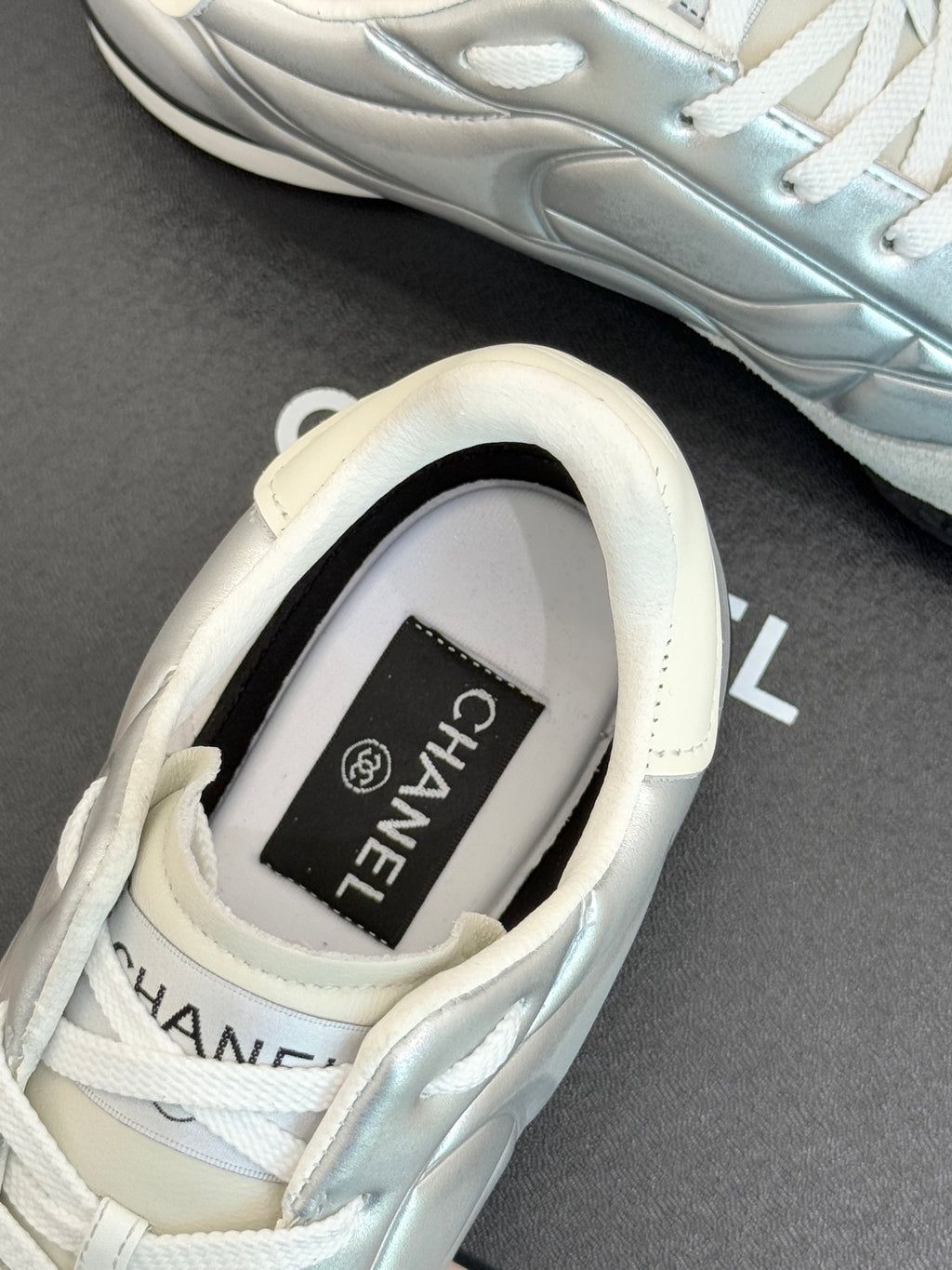 Chanel ladies white sneaker inner tongue, Chanel label visible