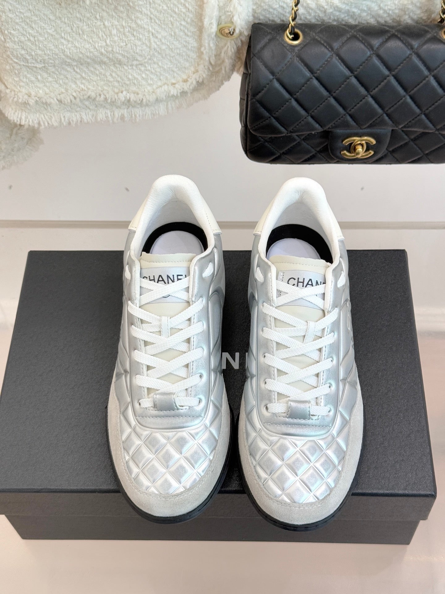 Chanel ladies white sneakers front view, lace-up with textured pattern