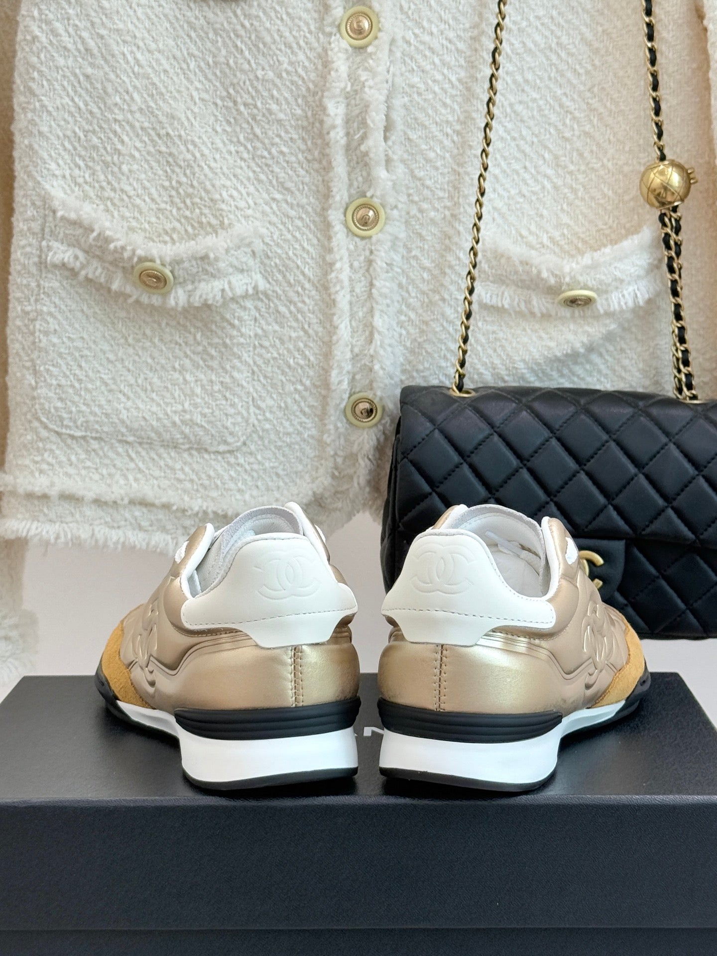 Chanel low-top sneakers in gold with white heel tabs and side stitching