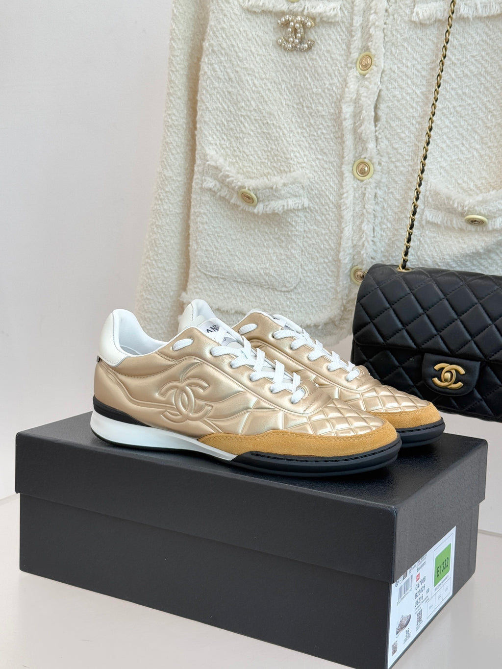 Chanel low-top sneaker in gold with white laces and quilted texture