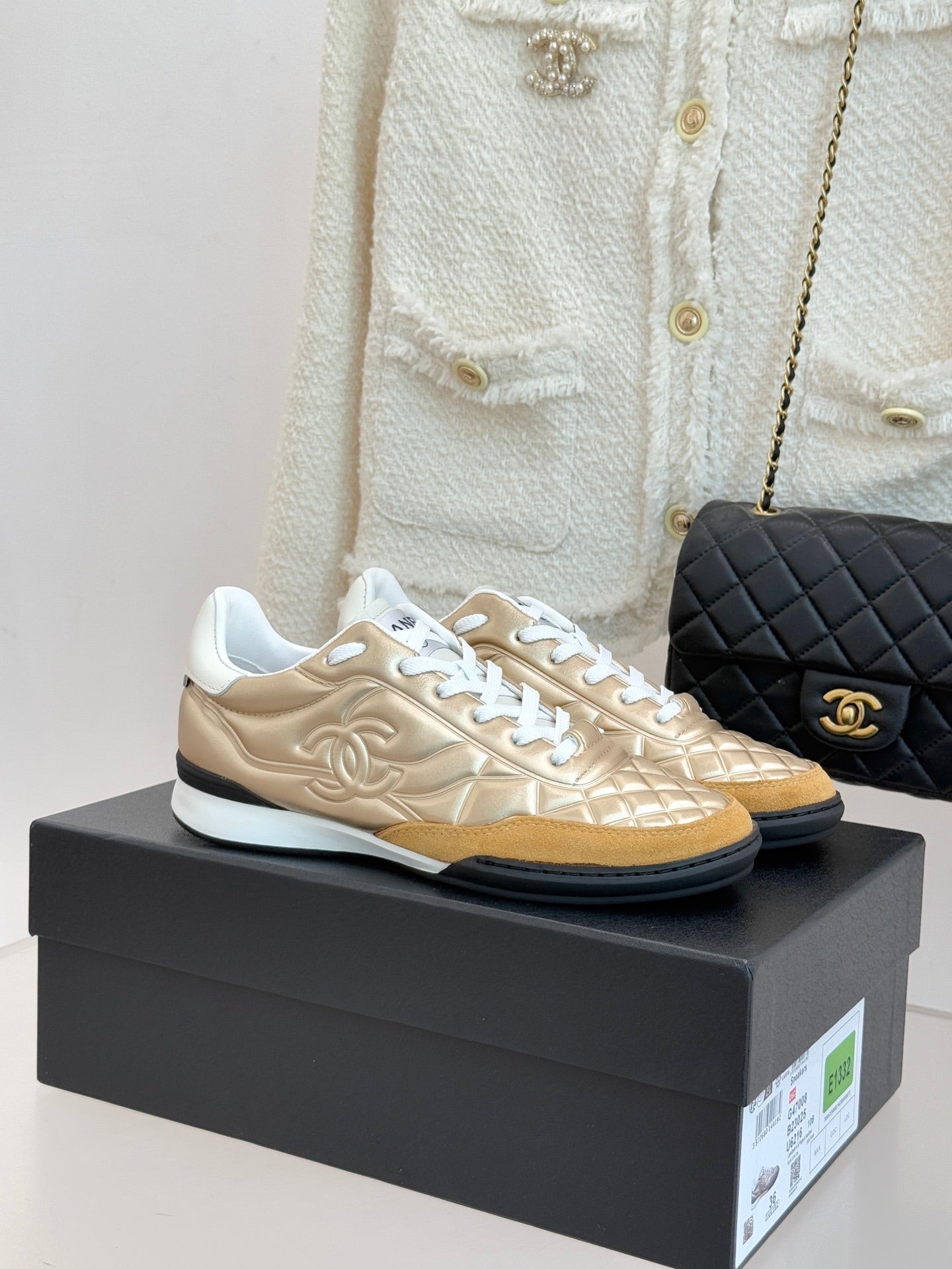 Chanel low-top sneaker in gold with white laces and quilted texture