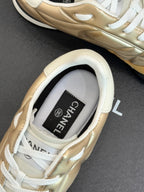 Chanel sneaker heel close-up in gold leather with white lining and label