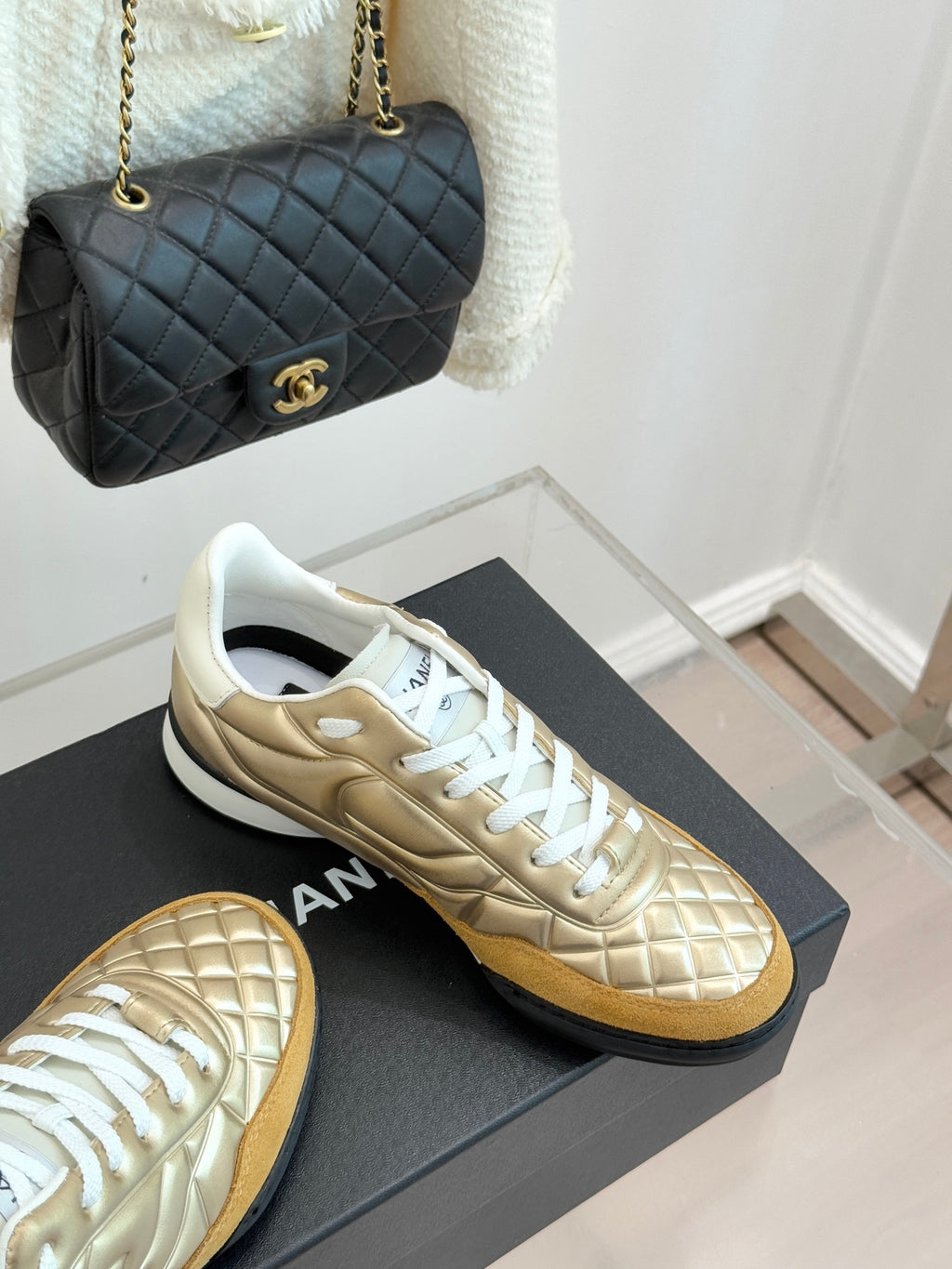 Chanel low-top sneakers with gold leather uppers and white lace-up panels