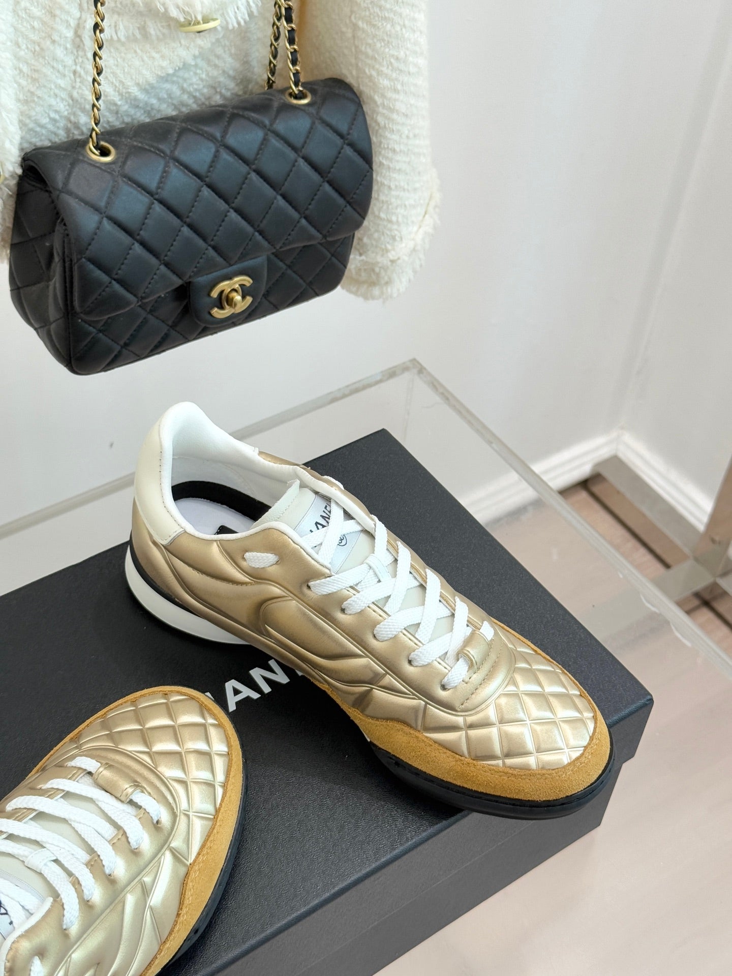 Chanel low-top sneakers with gold leather uppers and white lace-up panels