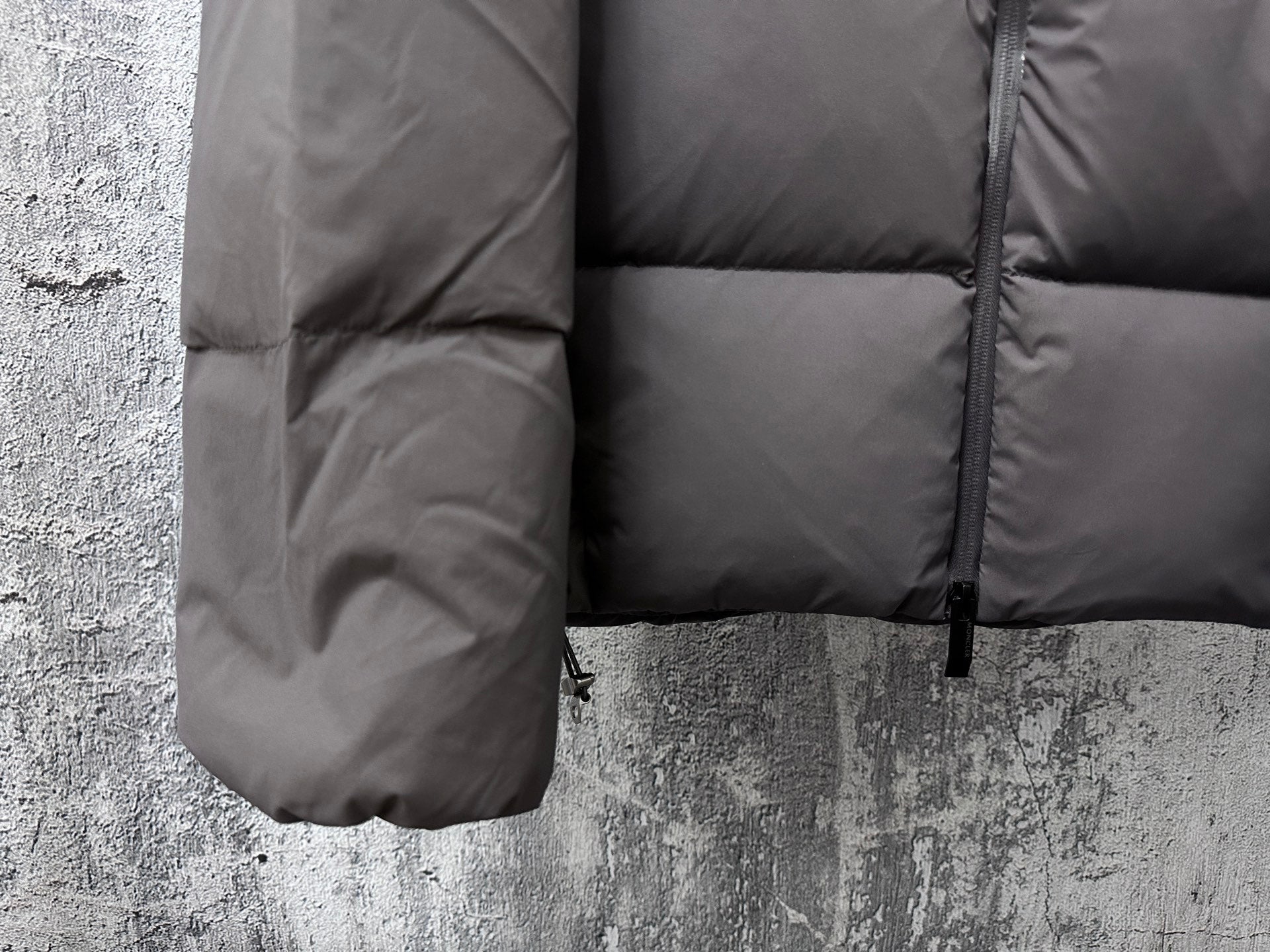 Long padded jacket side panel with quilted sections and zipper, dark gray