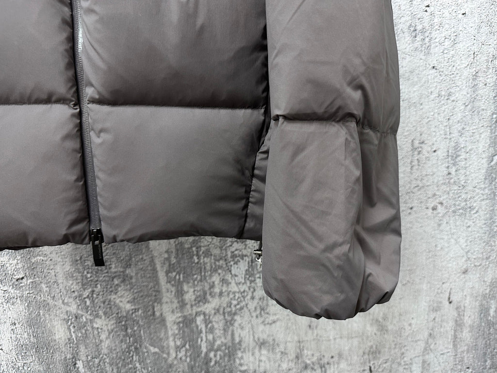 Long padded jacket with front pocket opening and drawcord hem, dark gray